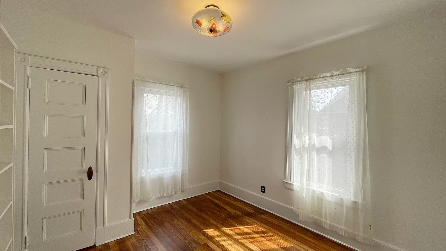 bedroom with two exposures, wood floor