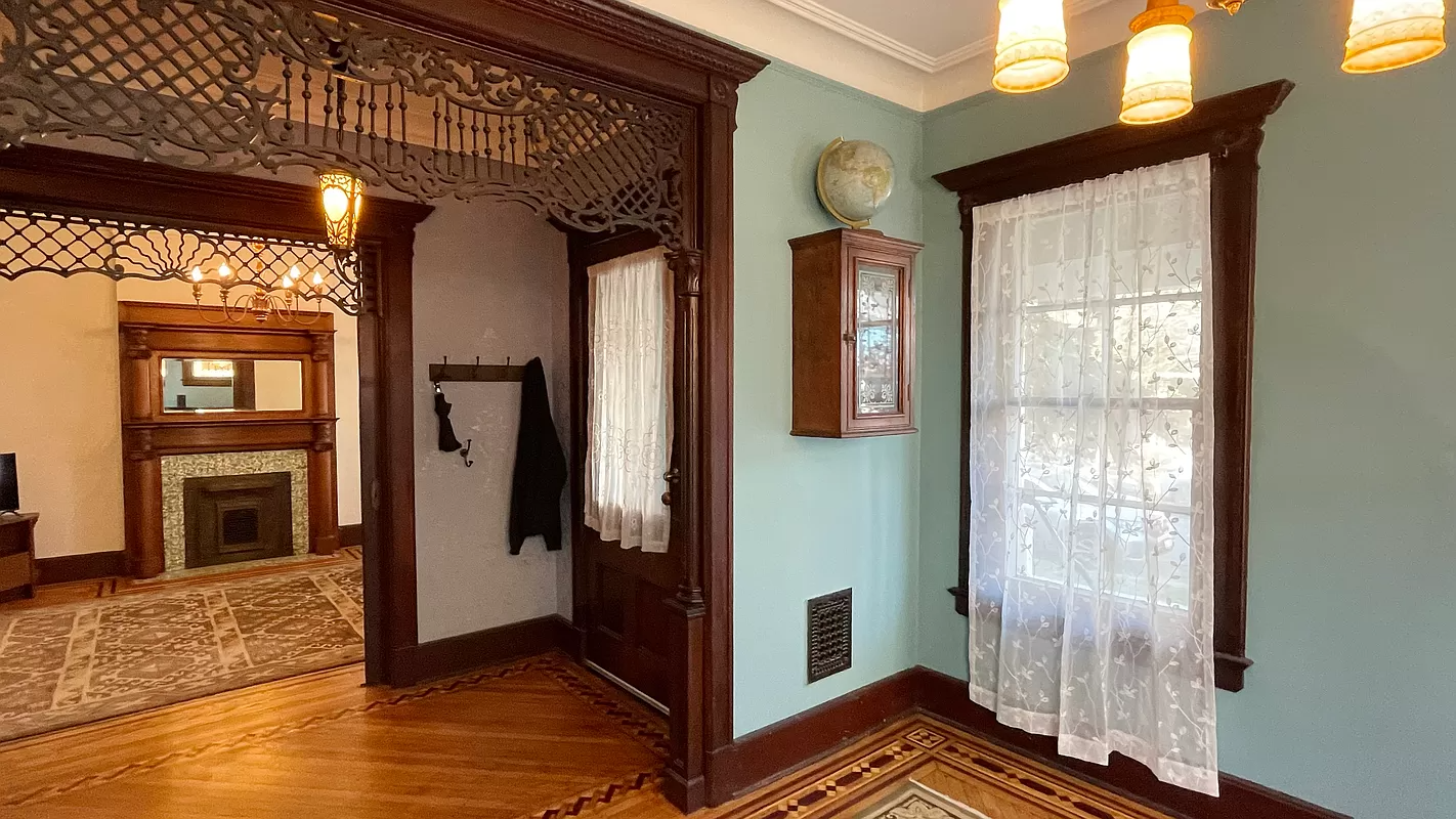 entry with fretwork, wood floor