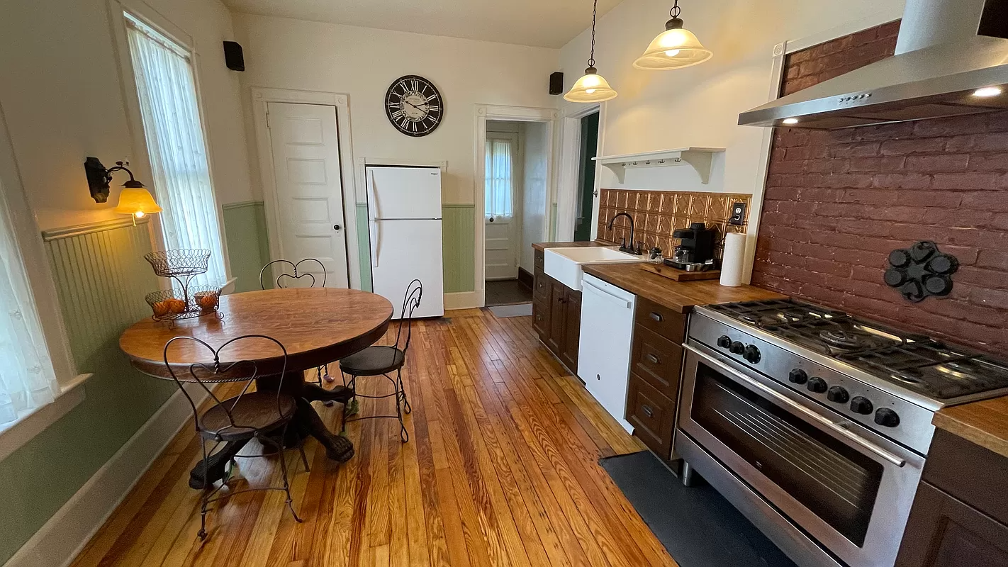 kitchen with wood floor, wainscoting