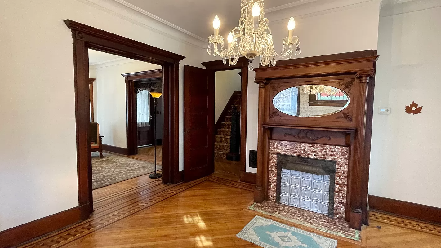 dining room with columned mantel, picture rails and wood floor