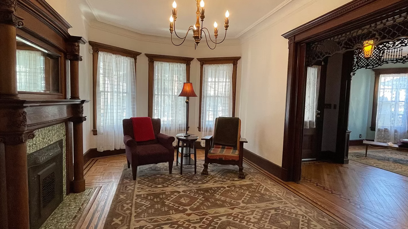 parlor with columned mantel, picture rails