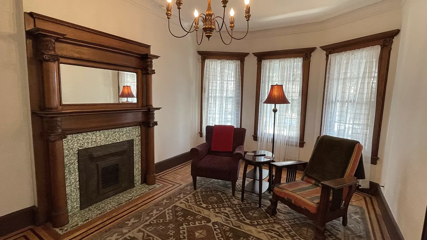 parlor with columned mantel, picture rails