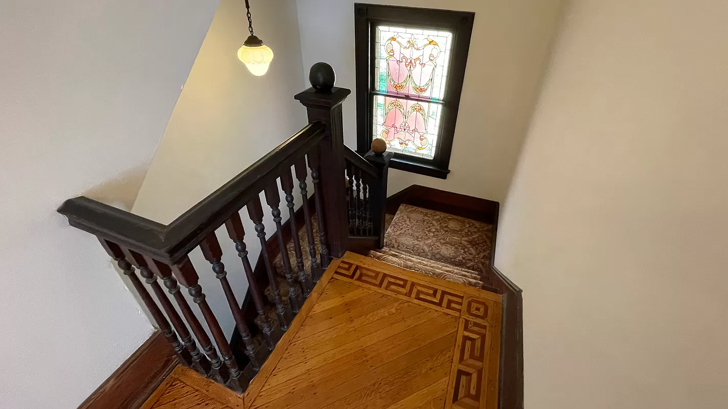 stair with stained glass window at landing