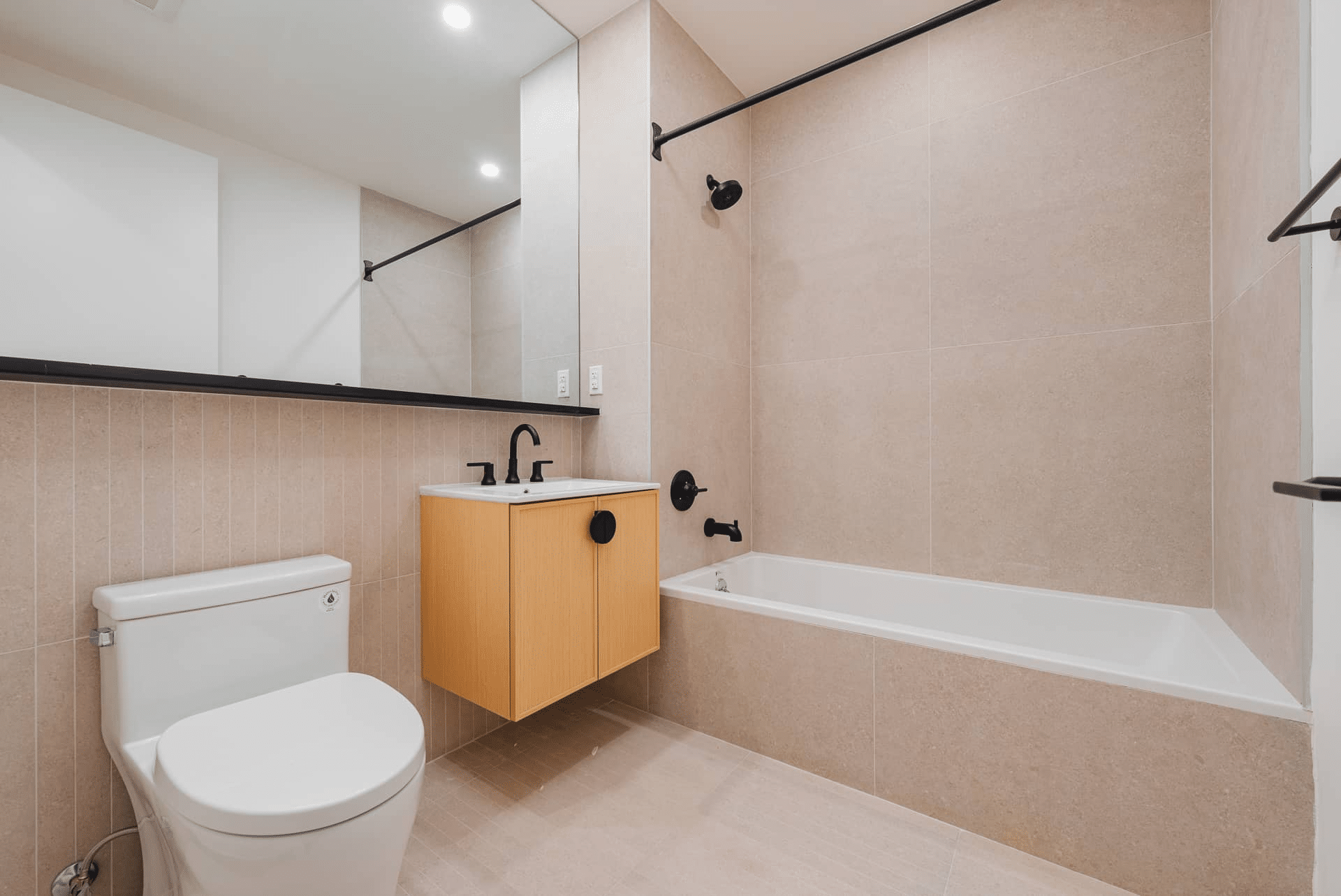 bathroom with beige tile and floating vanitty