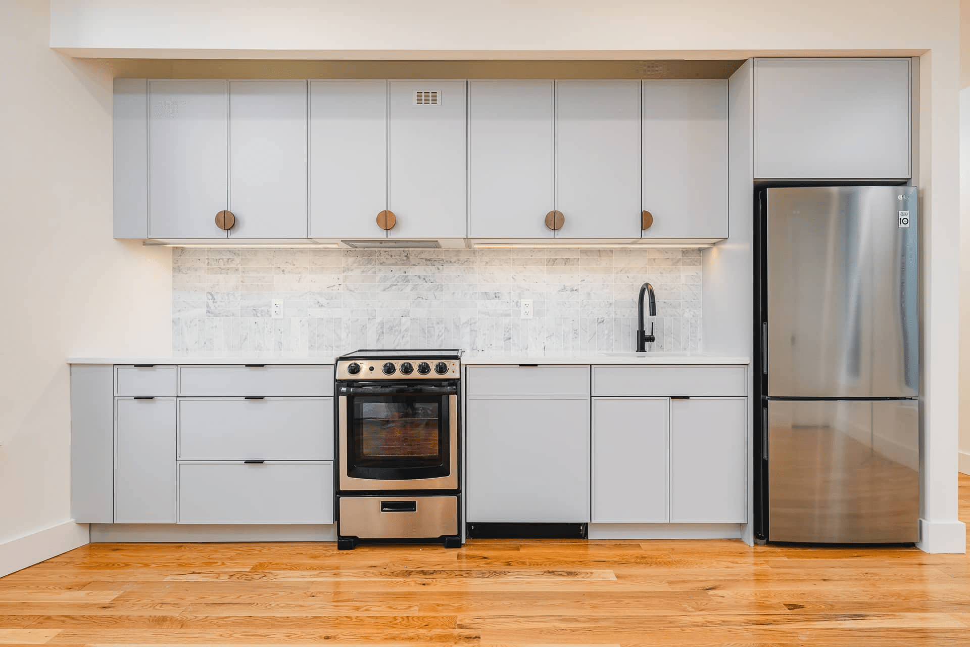 kitchen with grey cabinets and stainless steel appliances