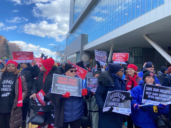 healthcare workers holding signs