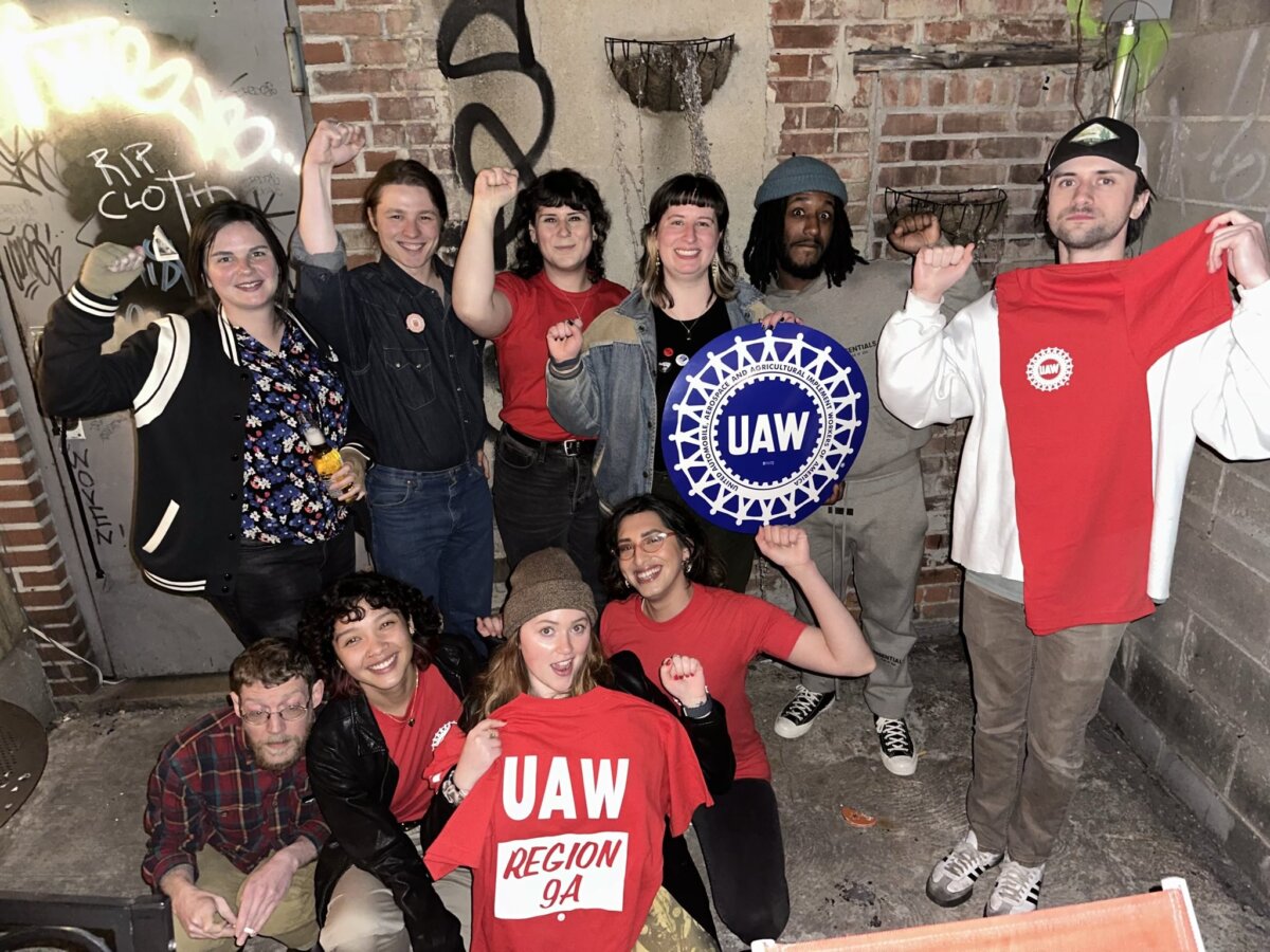 workers posing with a union sign