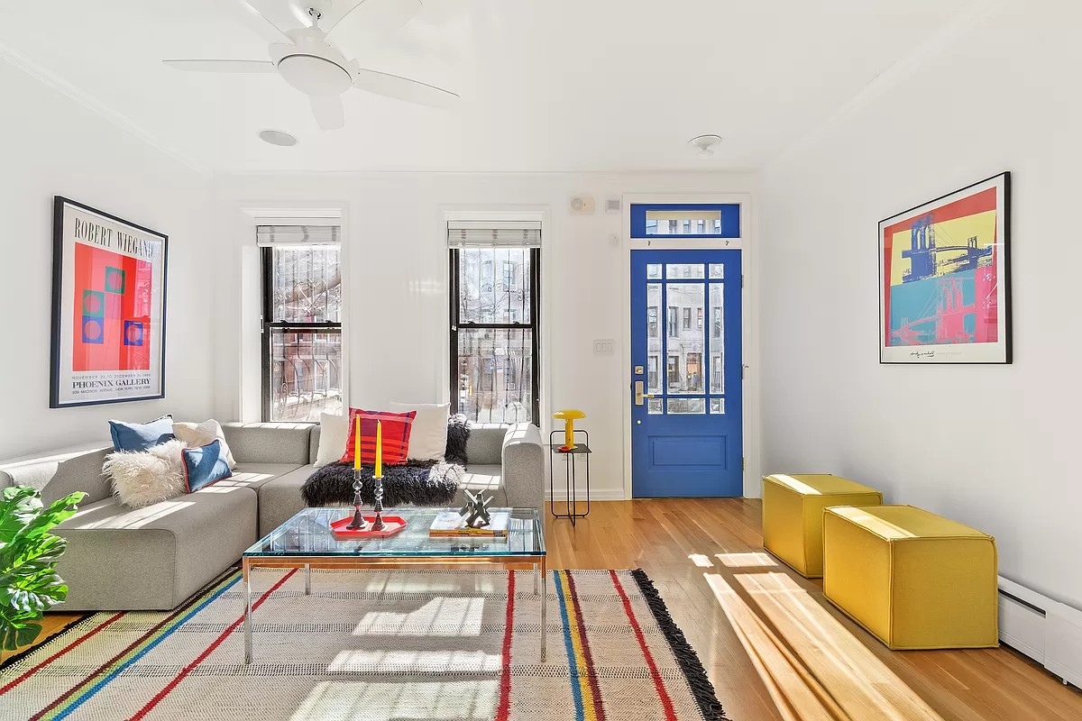 living room with a blue door and wood floors
