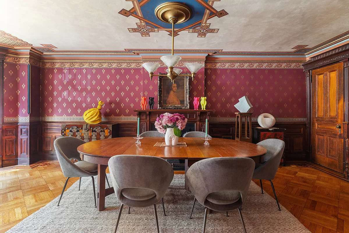 dining room with wainscoting, wallpaper and wood floor