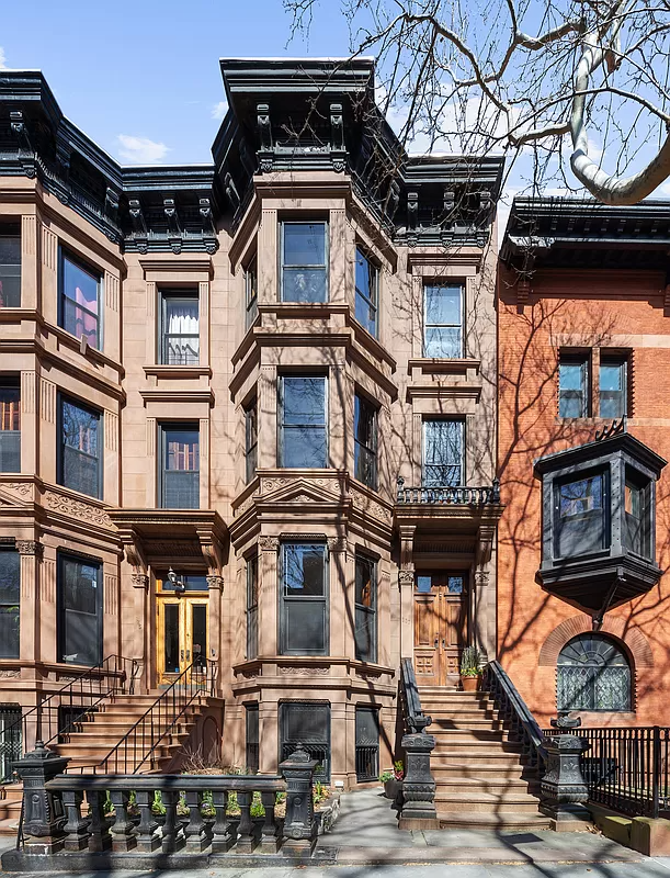 brownstone exterior with full height angled bay