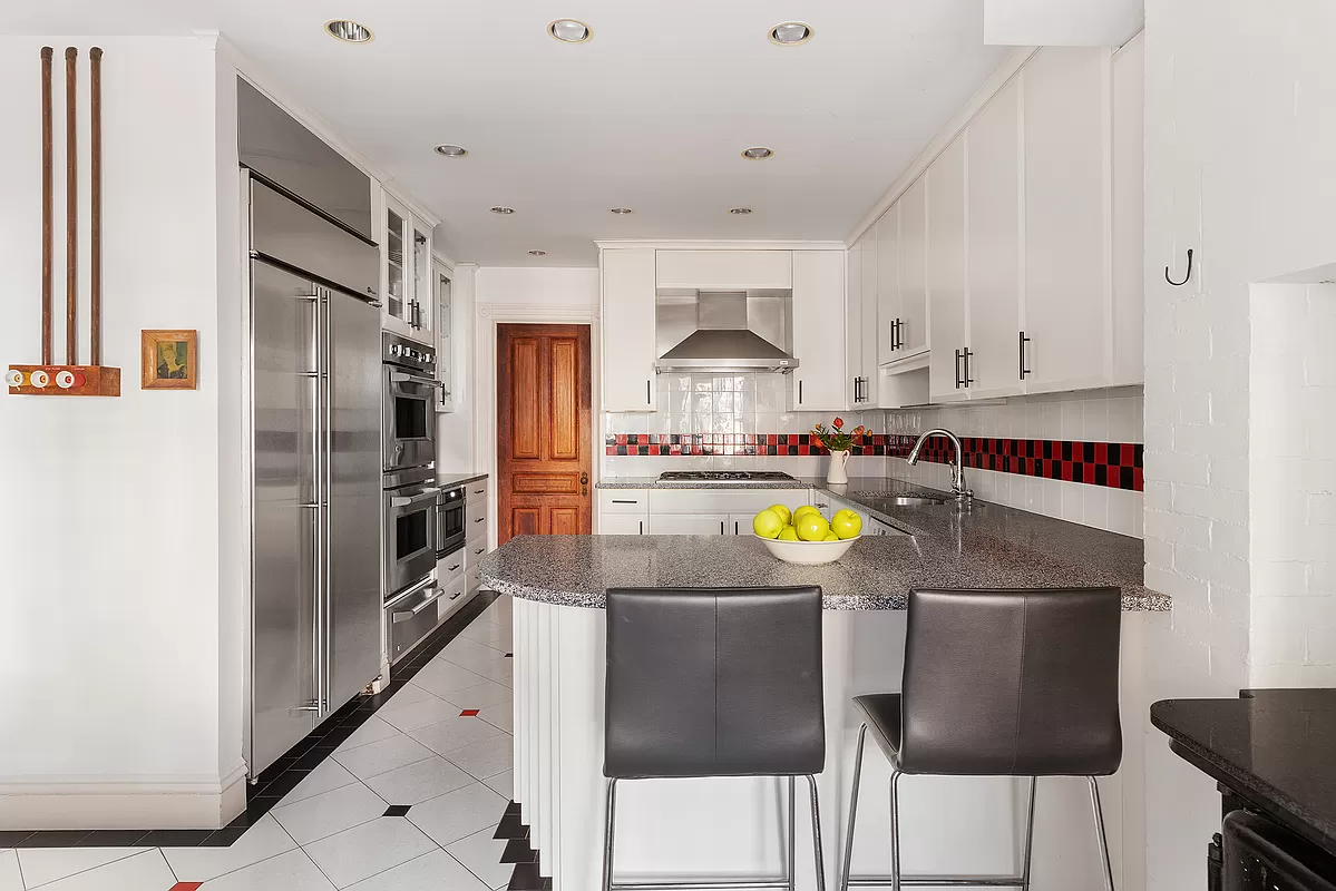 kitchen with white cabinets, checkerboard backsplash, and recessed lighting