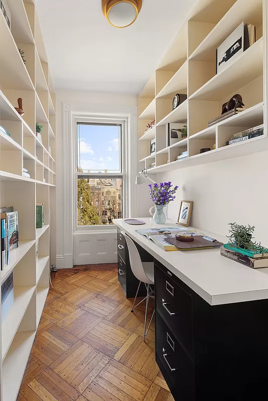 narrow room set up as an office with built-ins