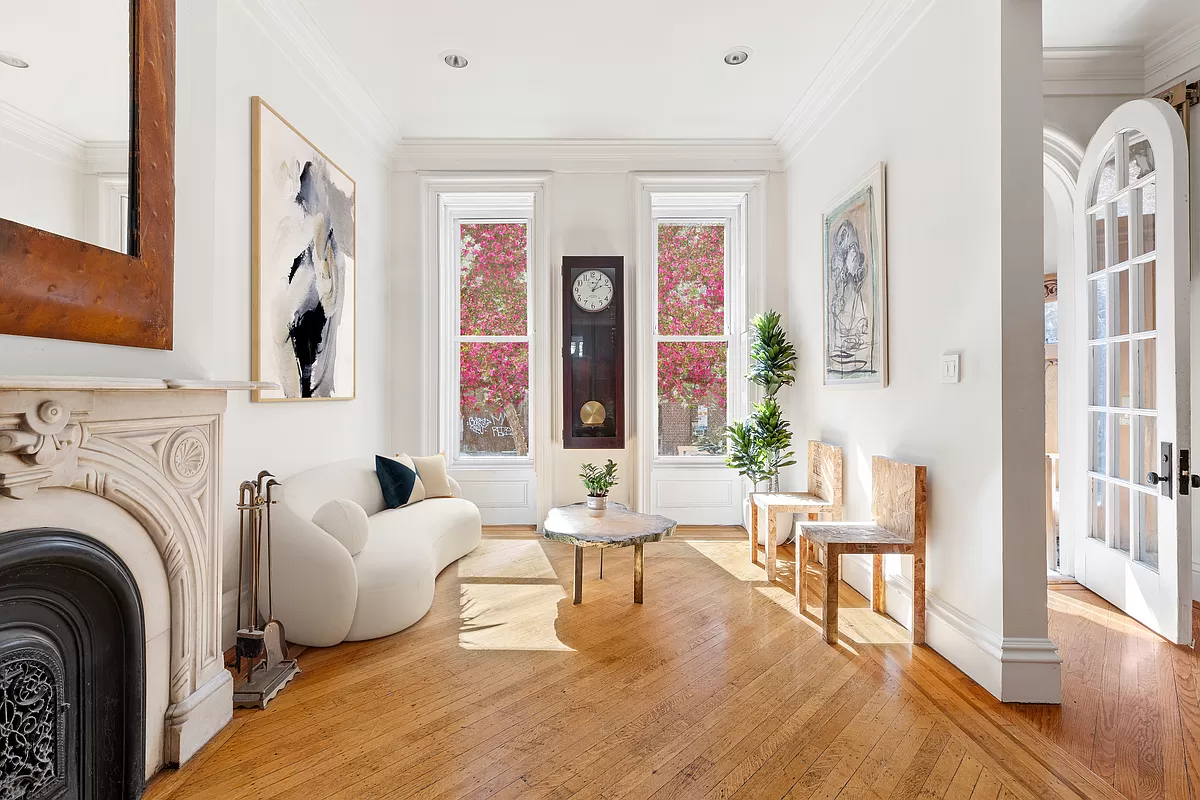 parlor with a marble mantel and wood floor