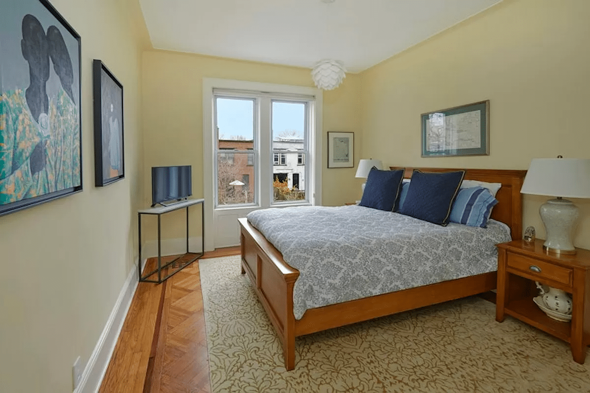 bedroom with a wood floor and yellow walls