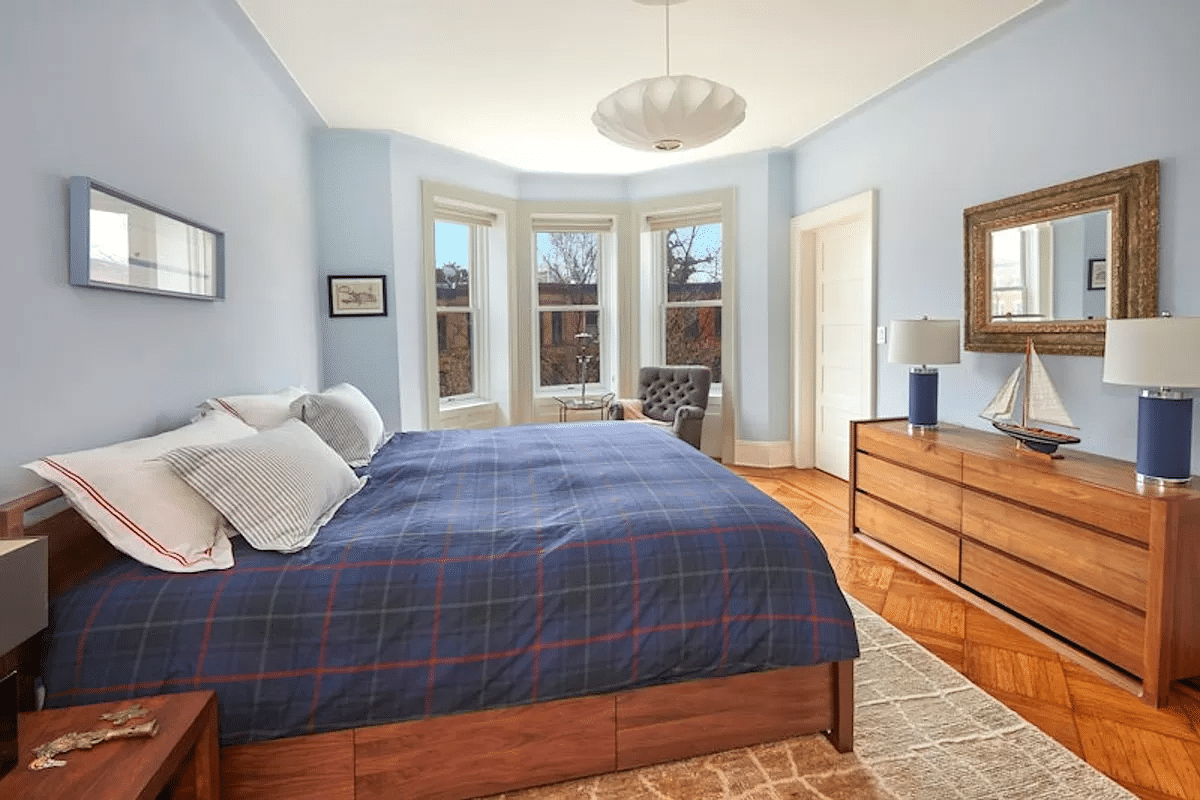 bedroom with wood floor and bay window