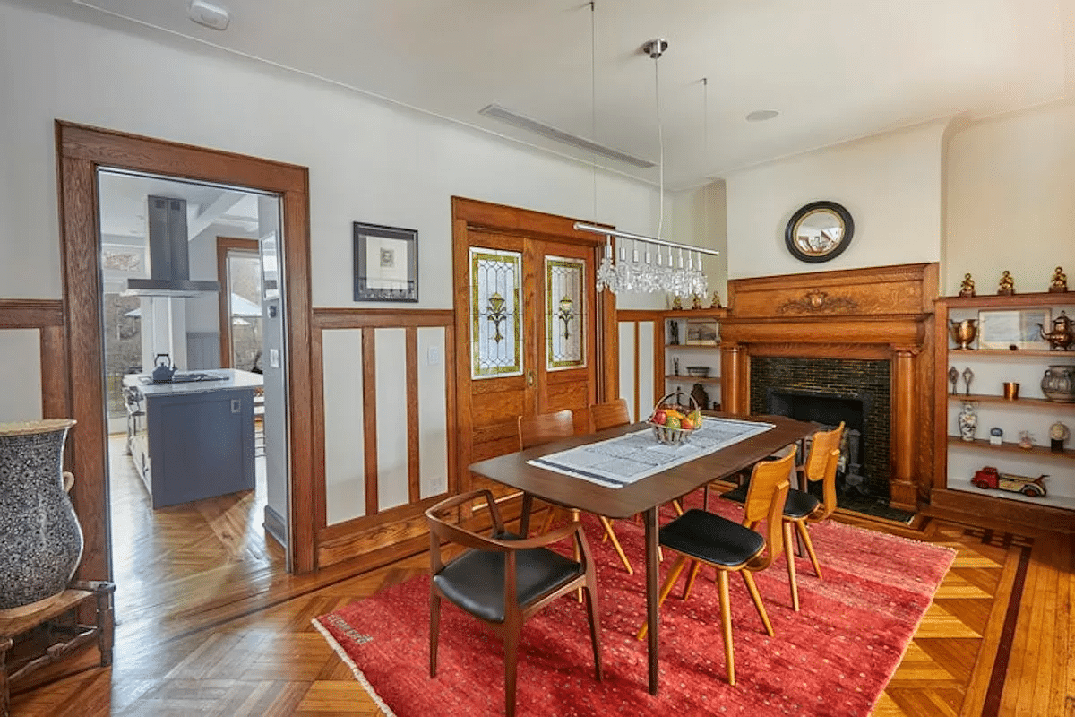 dining room with wainscoting, stained glass pocket doors, mantel