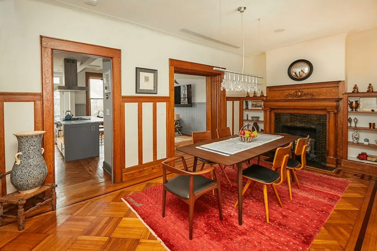 dining room with wainscoting, mantel, built-ins