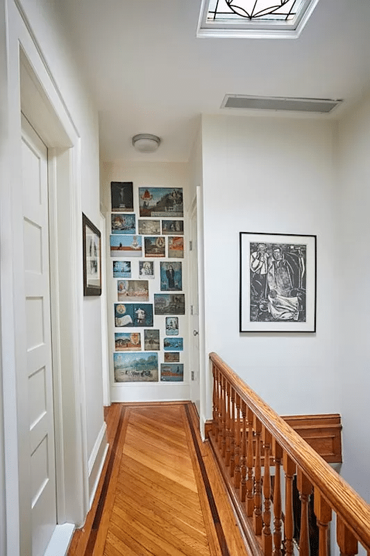 hallway with wood floor, skylight