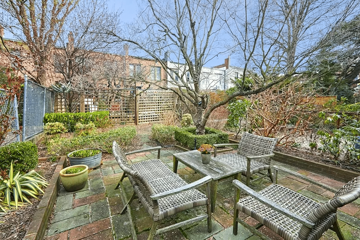 patio with room for dining with planting beds on the edges