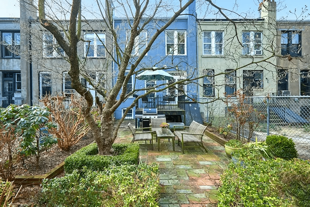 rear yard with view of the blue painted rear facade of the house