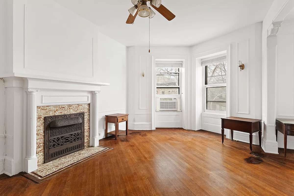 bedroom with white painted columned mantel and wall moldings