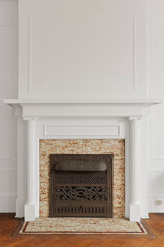 detail of columned mantel with original tile surround