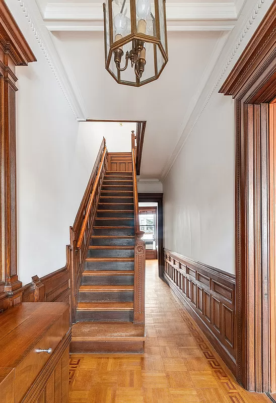 entry with wainscoting and stair to second floor