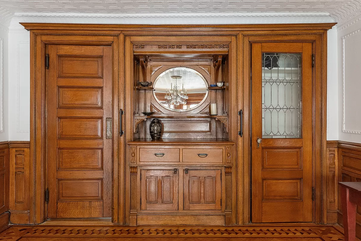 built-in cabinet with mirror and display shelves in the garden level dining room