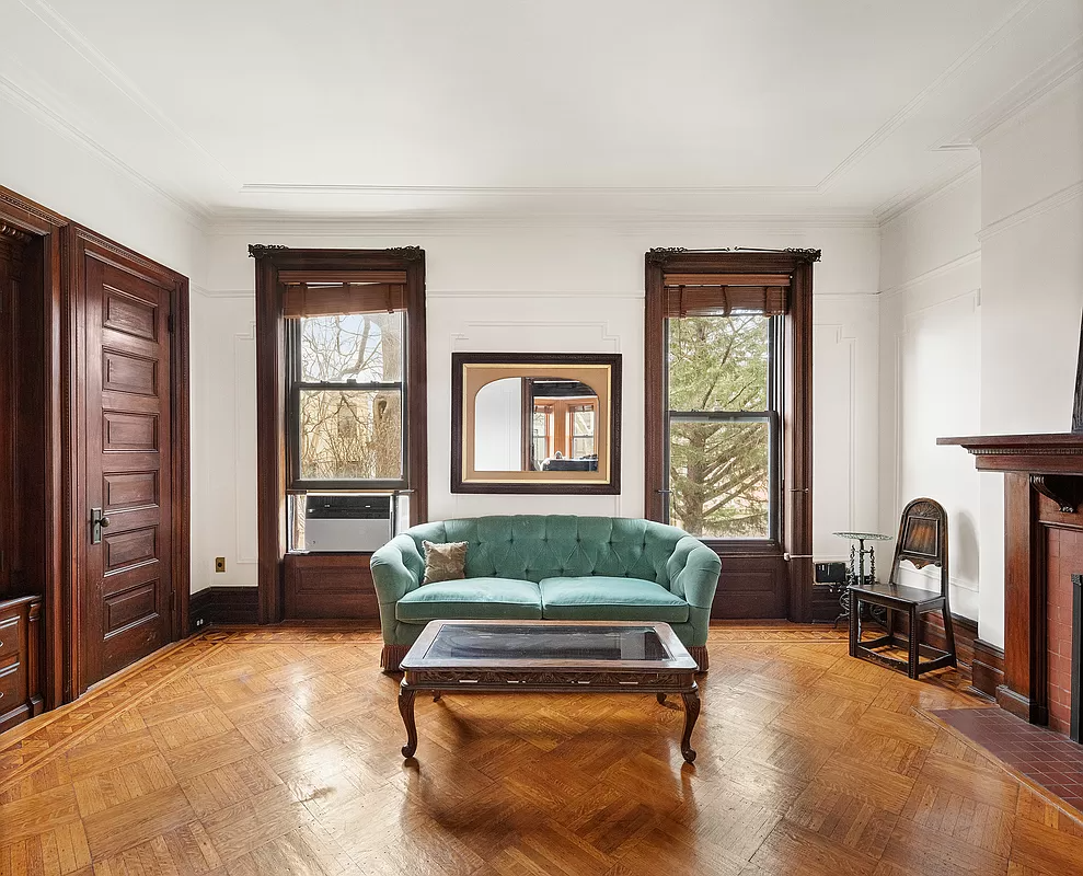 rear parlor with built-ins and a wood mantel