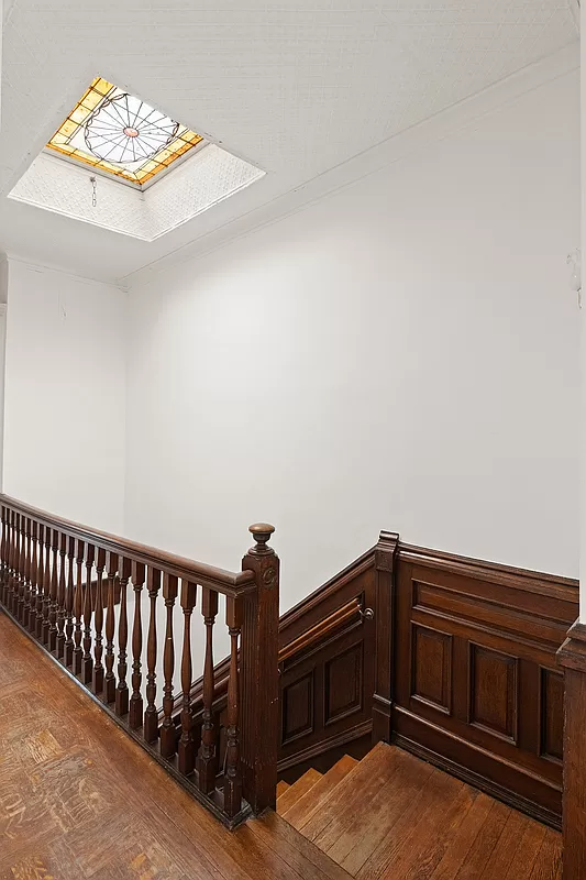 top floor stair hall with stained glass skylight