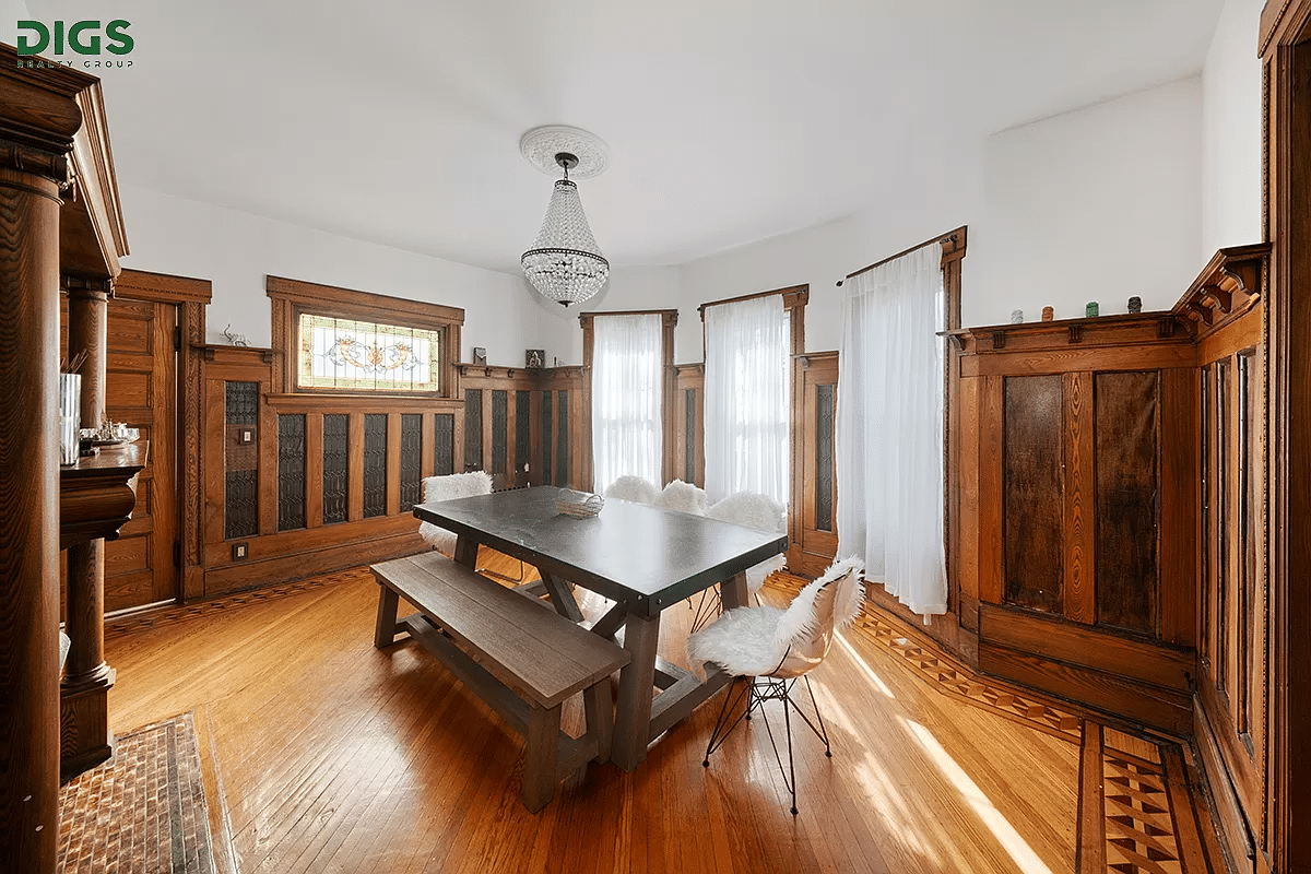 dining room with wainscoting and a mantel