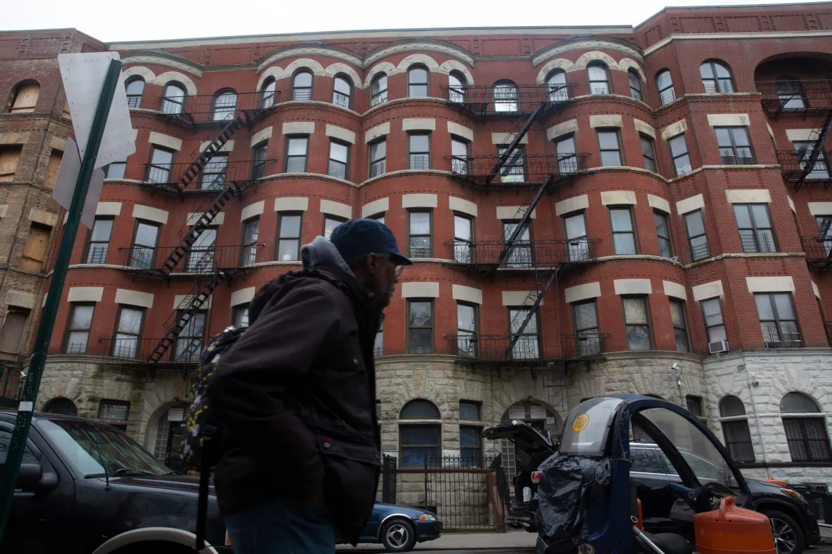 a person walks by an apartment building