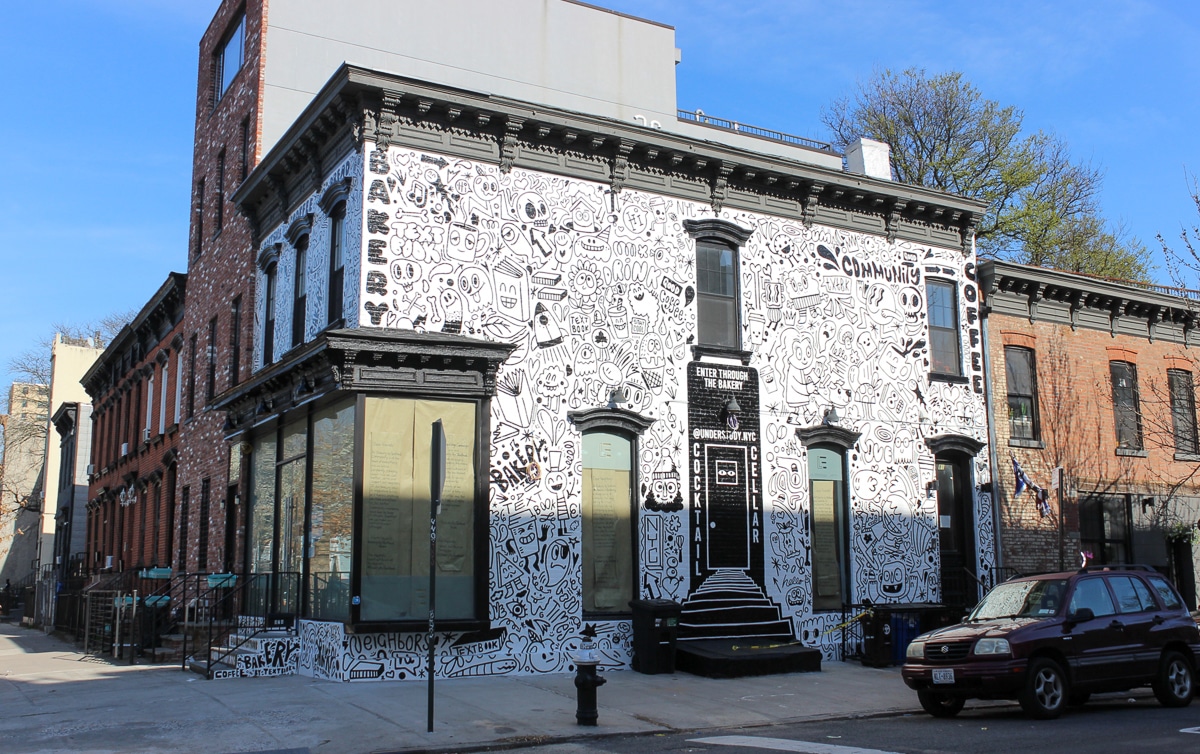 the corner building showing the black and white illustrations painted on the whole building
