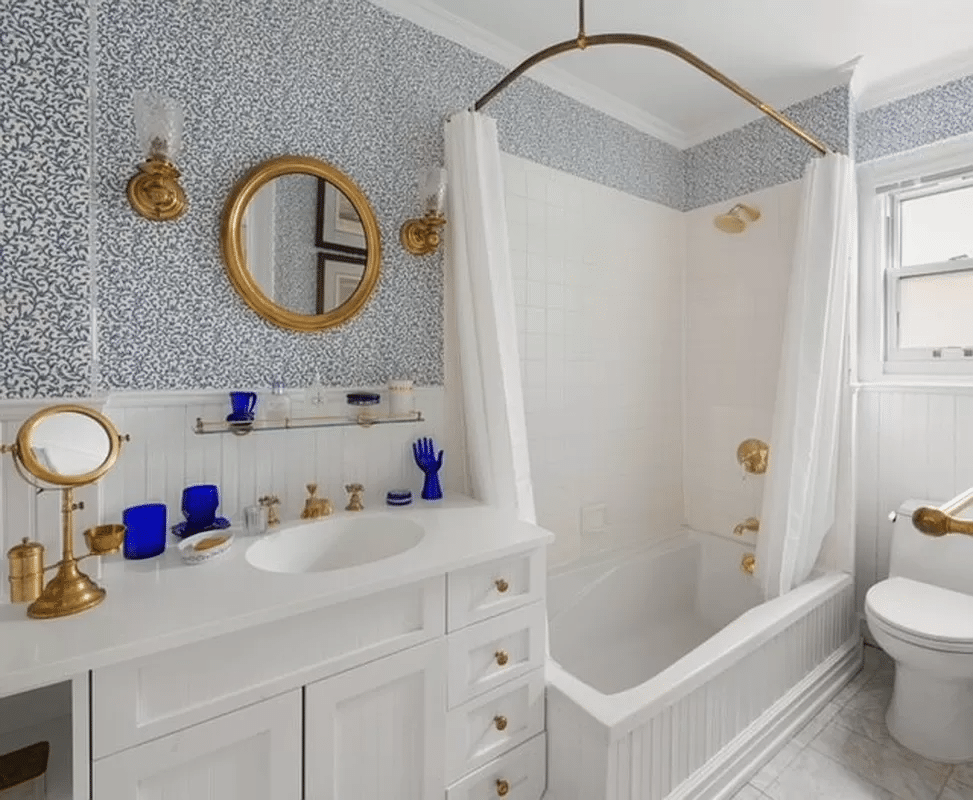 bathroom with white fixtures and blue wallwpaper