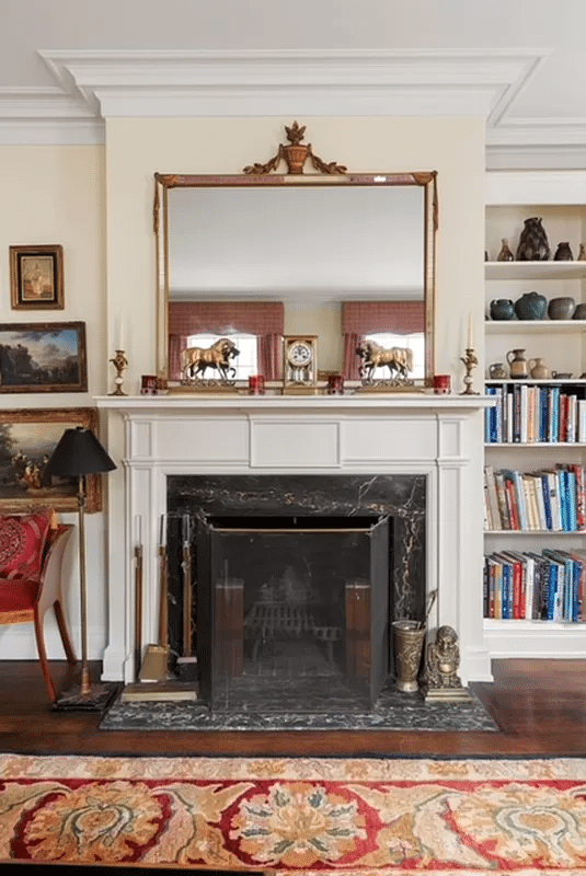 painted mantel in living room with black marble surround and hearth