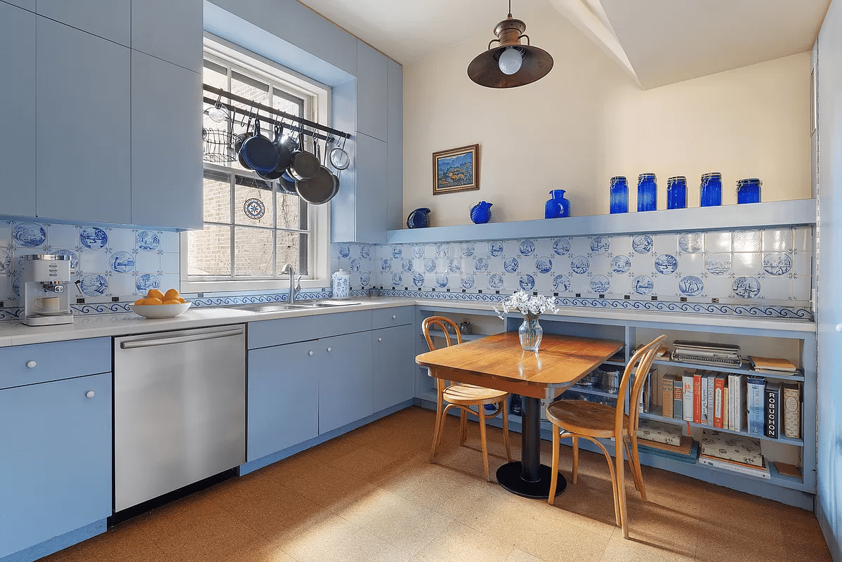 kitchen with blue cabinets and Delft tile backspash