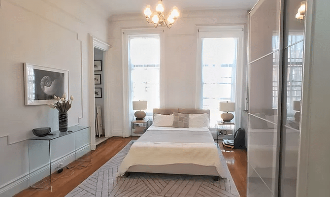 bedroom with two windows, wall moldings