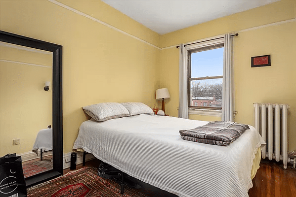 bedroom with yellow walls and a picture rail