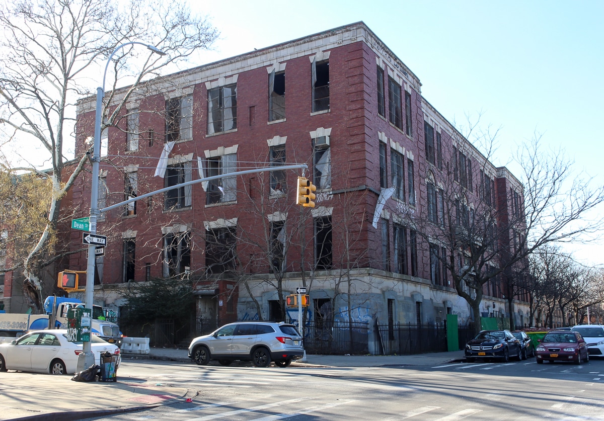 building with plastic blowing out of windows