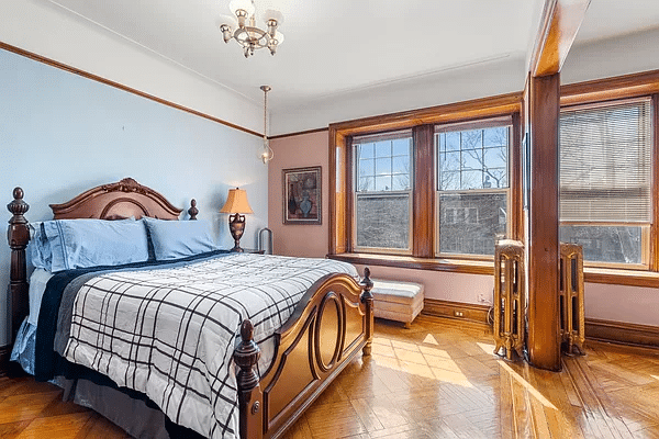bedroom with wood floor, picture rail, blue walls