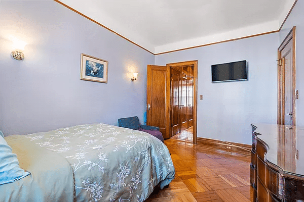 bedroom with wood floor, picture rails