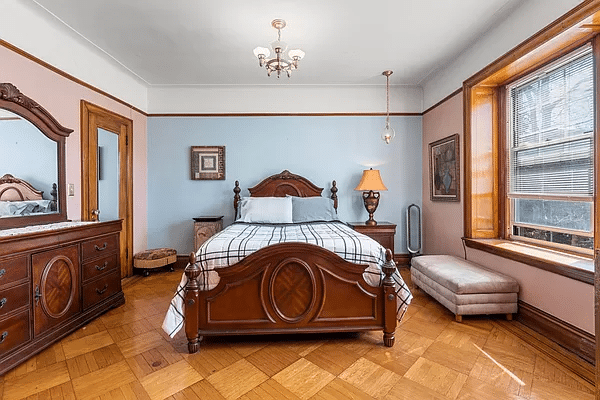 bedroom with wood floor, picture rail, blue walls