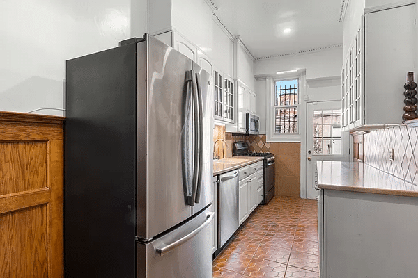 kitchen with white cabinets and tile floor