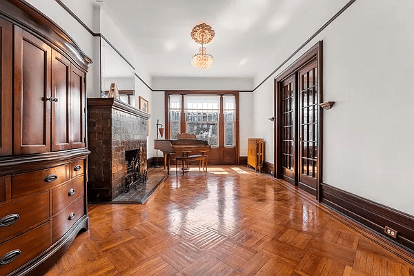 living room with wood floors and a tile mantel