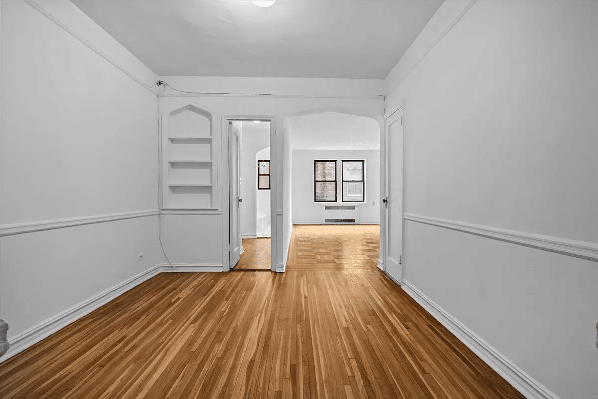 foyer with niche and arched doorway into living area