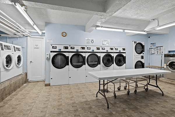 laundry room with row of dryers and two rows of washers