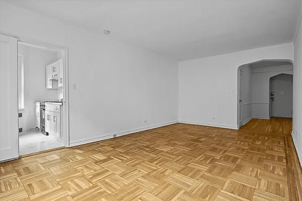 living are with parquet floor and view into kitchen