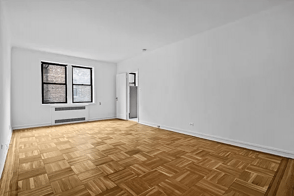 living area with two windows and a parquet floor