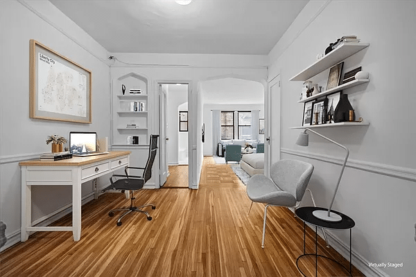 virtually staged foyer with desk and shelves on wall