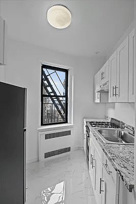 kitchen with white cabinets and floor tile